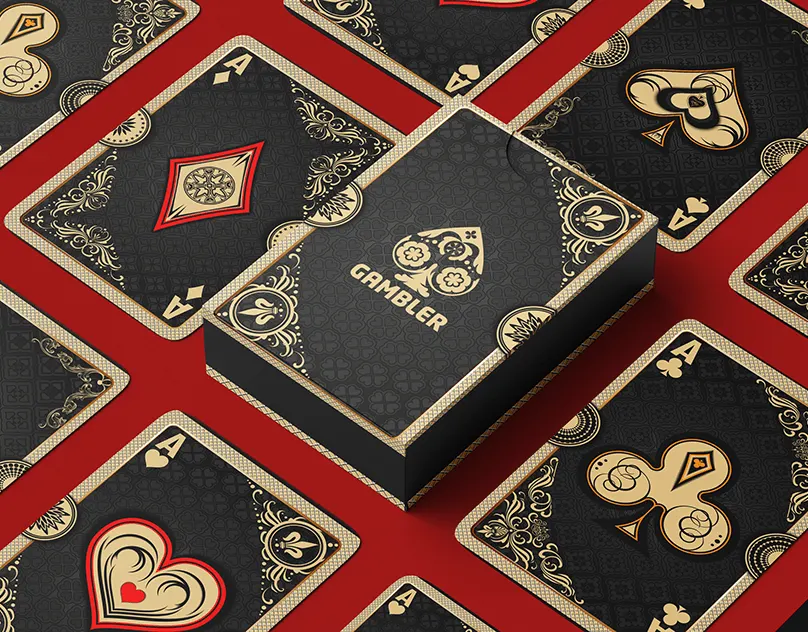 Black and gold Gambler card box on a pattern of ornate playing cards