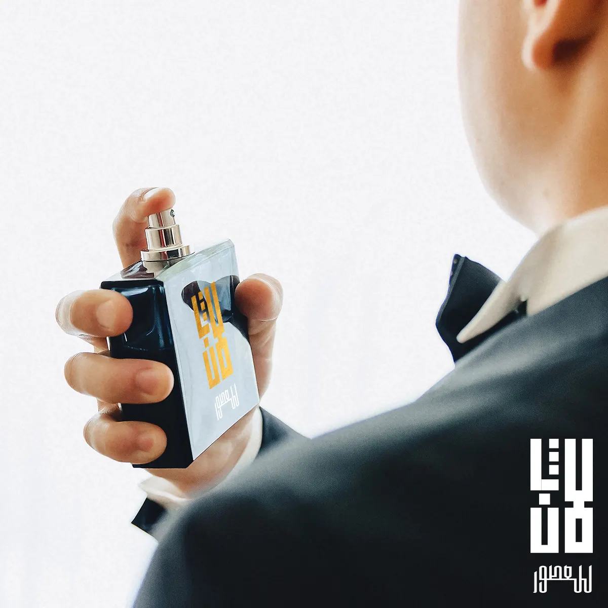Man in a suit holding a Lafen perfume bottle