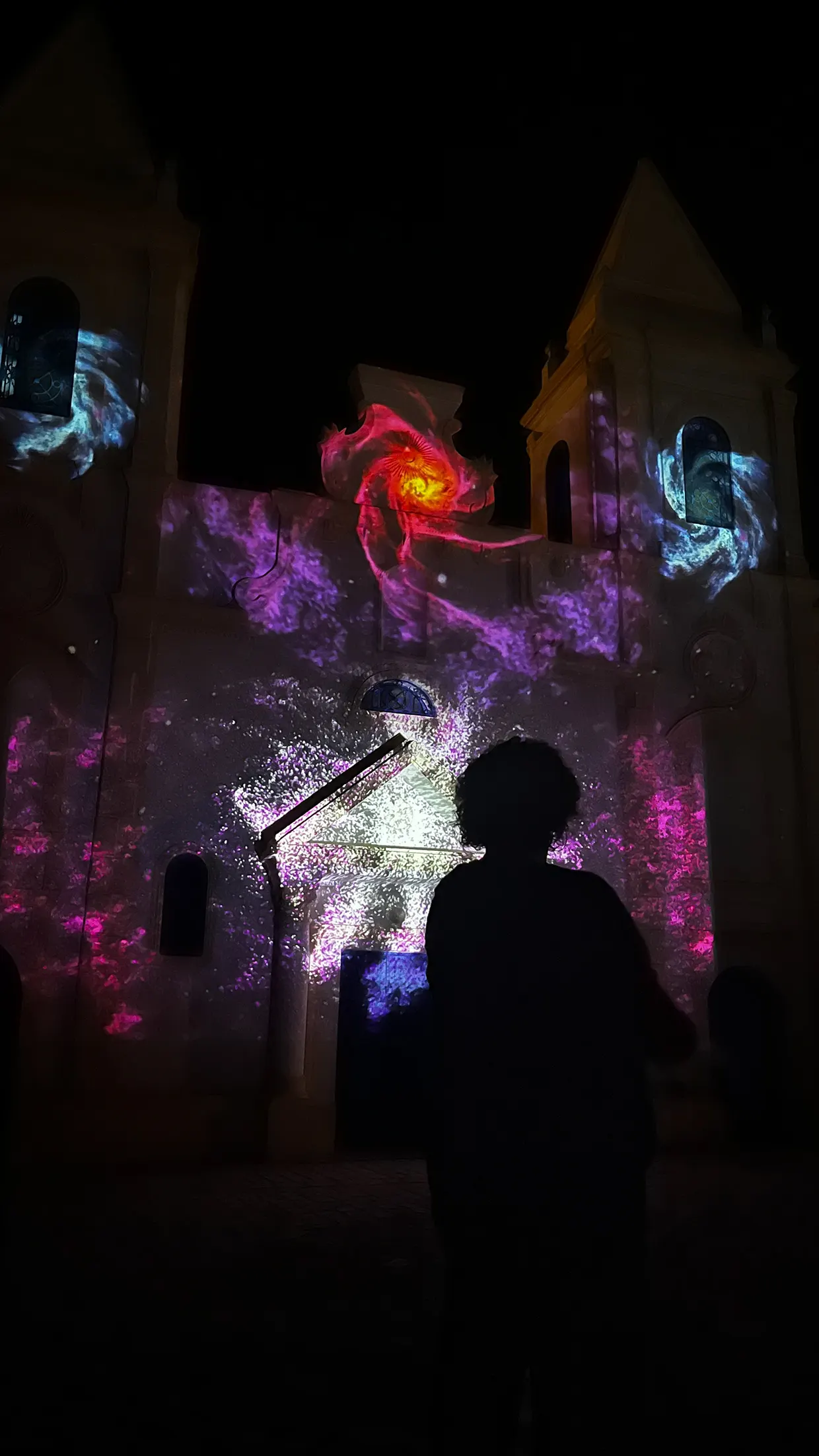 Visitor standing in front of the church facade during the projection