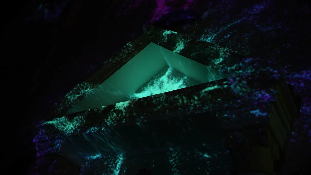 Teal particles flowing over the carved stone above the church door