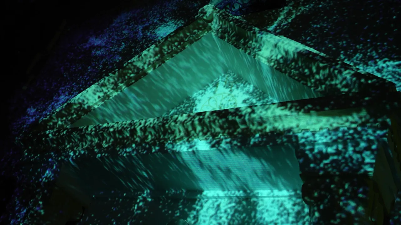 Close view of teal light pouring down the church pediment