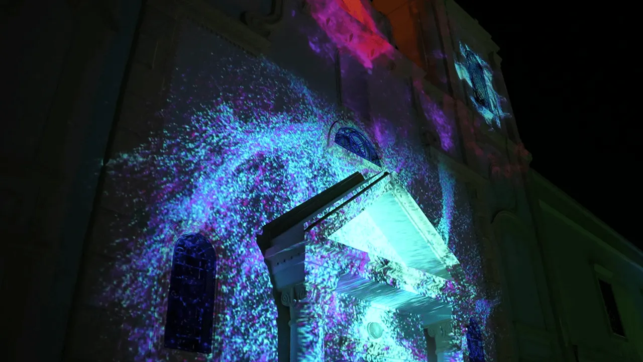 Blue particles swirling around the church entrance