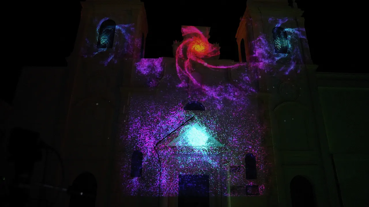 Red spiral galaxy shape above the church door, with violet particles below
